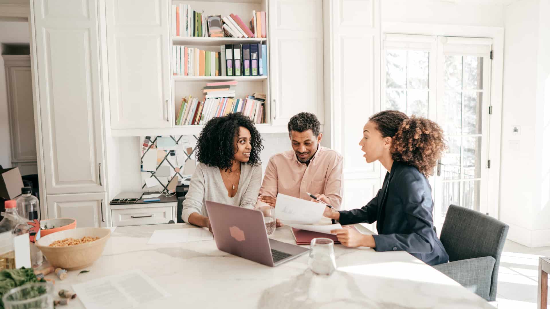 Diverse group discussing life insurance options at a modern office table.