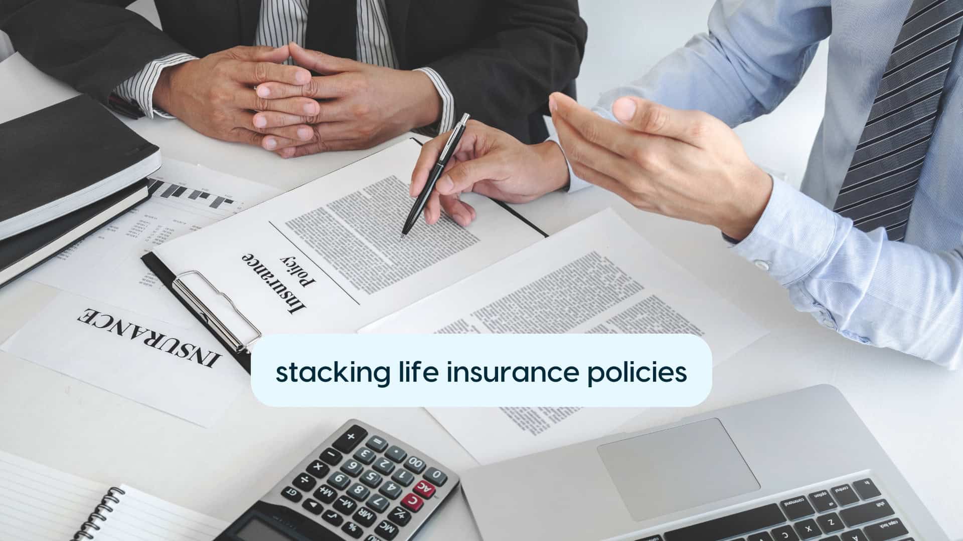 Businesspeople discussing stacking multiple life insurance policies at a meeting.